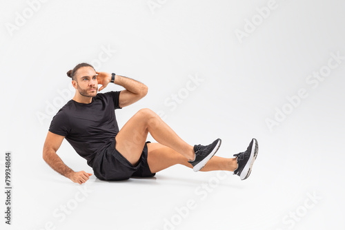 Man Sitting on Ground in Black Shirt and Shorts