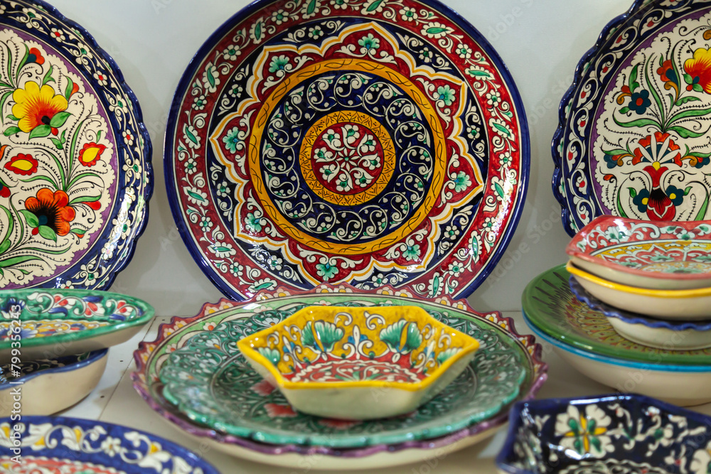 Traditional ceramics of Central Asia. Ancient traditional Uzbek ceramic dishes with national ornaments. Colorful handmade ceramics from Uzbekistan. Traditional ceramics of Central Asia. Ancient traditional Uzbek ceramic dishes with national ornaments. Colorful handmade ceramics from Uzbekistan.