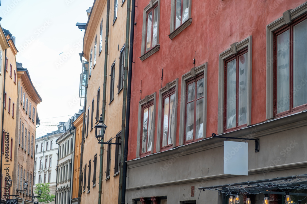 Fototapeta premium Sweden, vintage building in Stockholm, holiday at Gamla Stan. Hanging empty signboard over store.