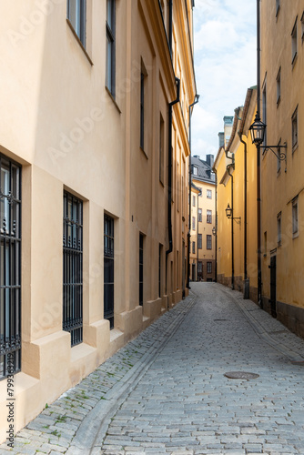 Narrow paved alleyway between building background at Gamla Stan Old Town  Stockholm Sweden. Vertical