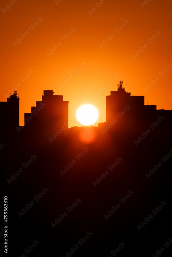Pôr do Sol entre prédios da cidade