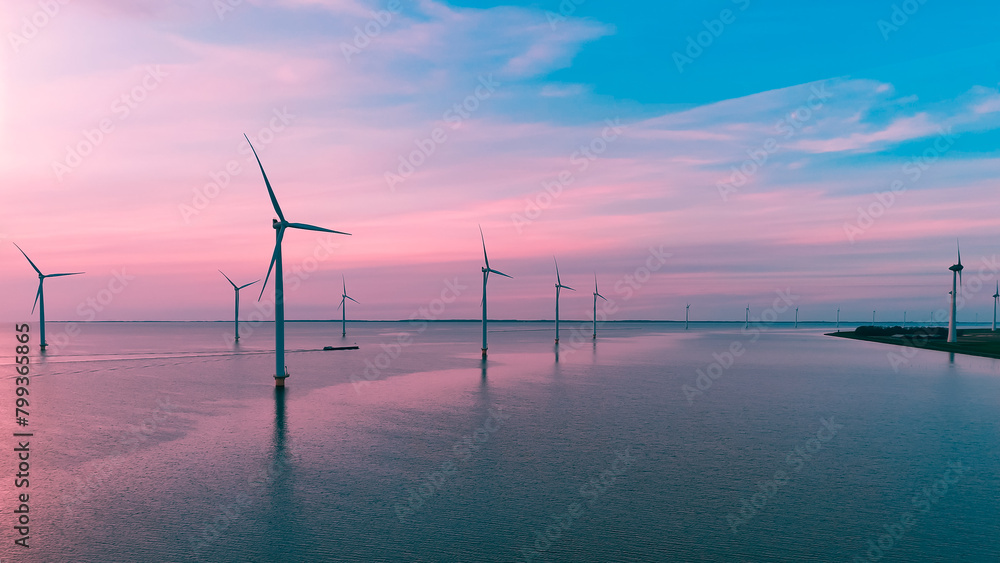 Aerial drone view wind turbine park ofsshore wind farm in the Netherlands on sunset.