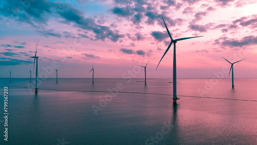 Aerial drone view wind turbine park ofsshore wind farm in the Netherlands on sunset.