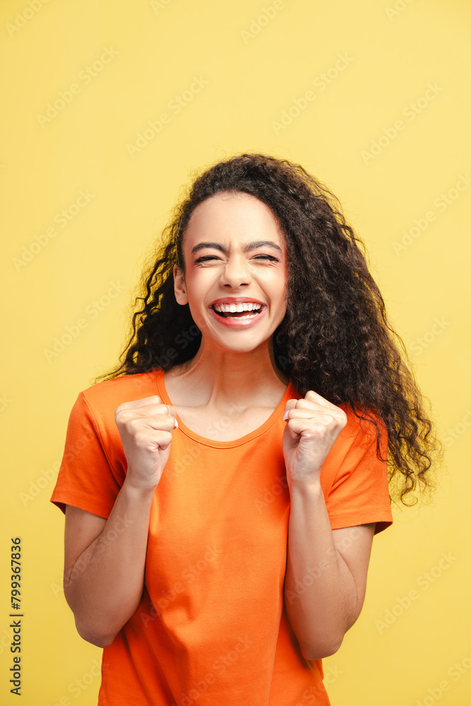 Portrait of beautiful smiling girl, teenager wearing orange t shirt rejoicing isolated Portrait of beautiful smiling girl, teenager wearing orange t shirt rejoicing isolated