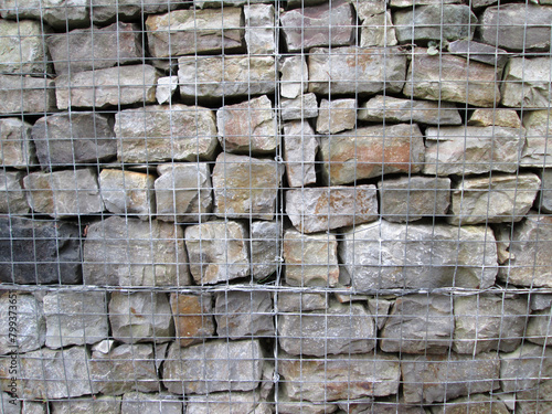 Grey stone blocks in a gambion wall construction 