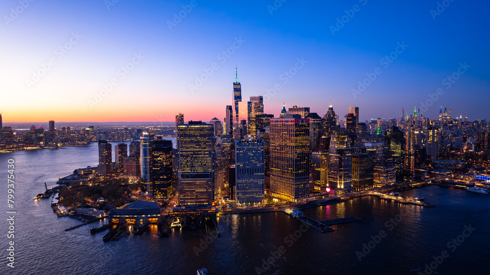 Beautiful city view with multiple lights on. New York panorama from drone photo above the East River. Aerial view.