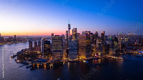 Beautiful city view with multiple lights on. New York panorama from drone photo above the East River. Aerial view.