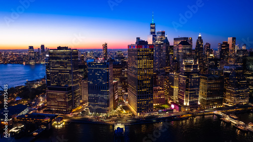 Beautiful city view with multiple lights on. New York panorama from drone photo above the East River. Aerial view.