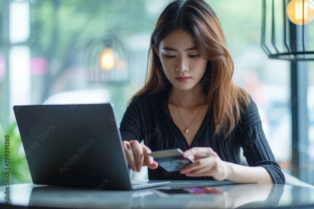 Asian woman using credit card and laptop for online shopping Asian woman using credit card and laptop for online shopping