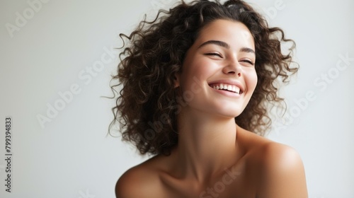 Portrait of a young woman with curly hair smiling