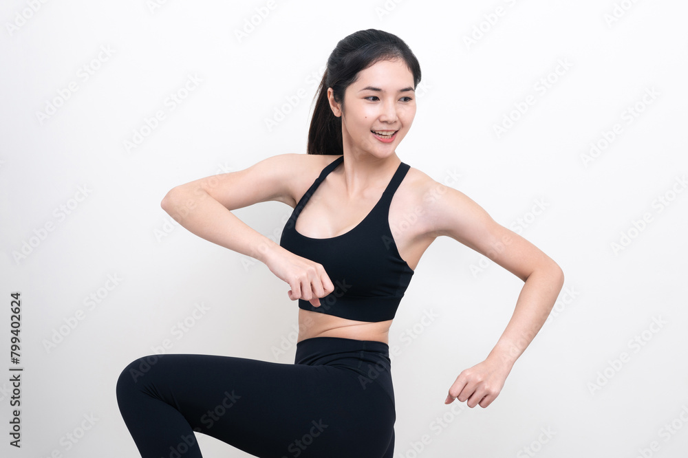 Attractive Asian woman in black workout clothes doing arm stretching on white background. Confident young female athlete body warm up before workout on isolated. Attractive Asian woman in black workout clothes doing arm stretching on white background. Confident young female athlete body warm up before workout on isolated.