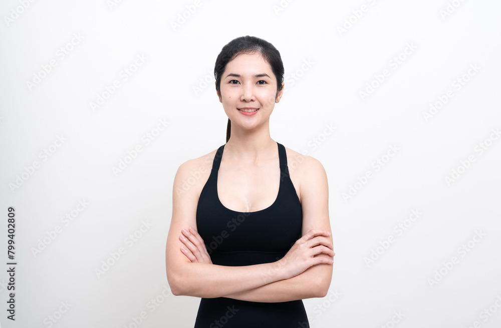 Attractive Asian woman in black workout clothes doing arm stretching on white background. Confident young female athlete body warm up before workout on isolated. Attractive Asian woman in black workout clothes doing arm stretching on white background. Confident young female athlete body warm up before workout on isolated.