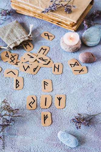 Fortune telling from four Scandinavian runes on a table in mystical decor vertical view