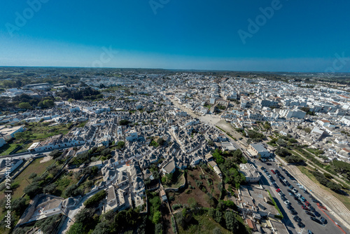  Aerial drone view of Beautiful stone Trulli houses with narrow streets in village of Alberobello. Picturesque village on a hill in Apulia, southern italy.  © Anze