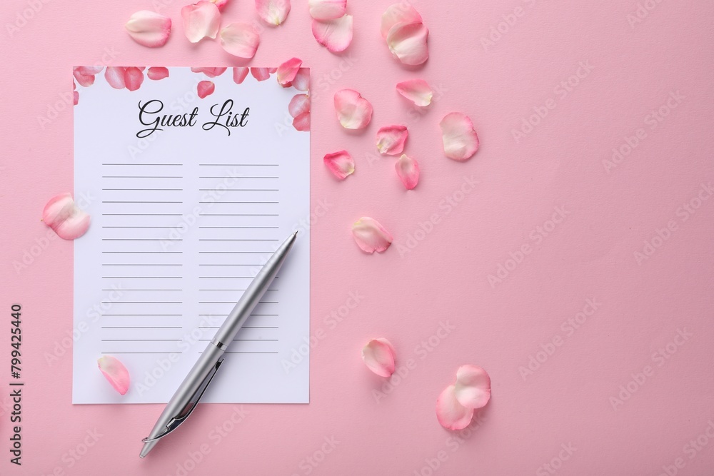 Guest list, pen and petals on pink background, flat lay. Space for text Guest list, pen and petals on pink background, flat lay. Space for text