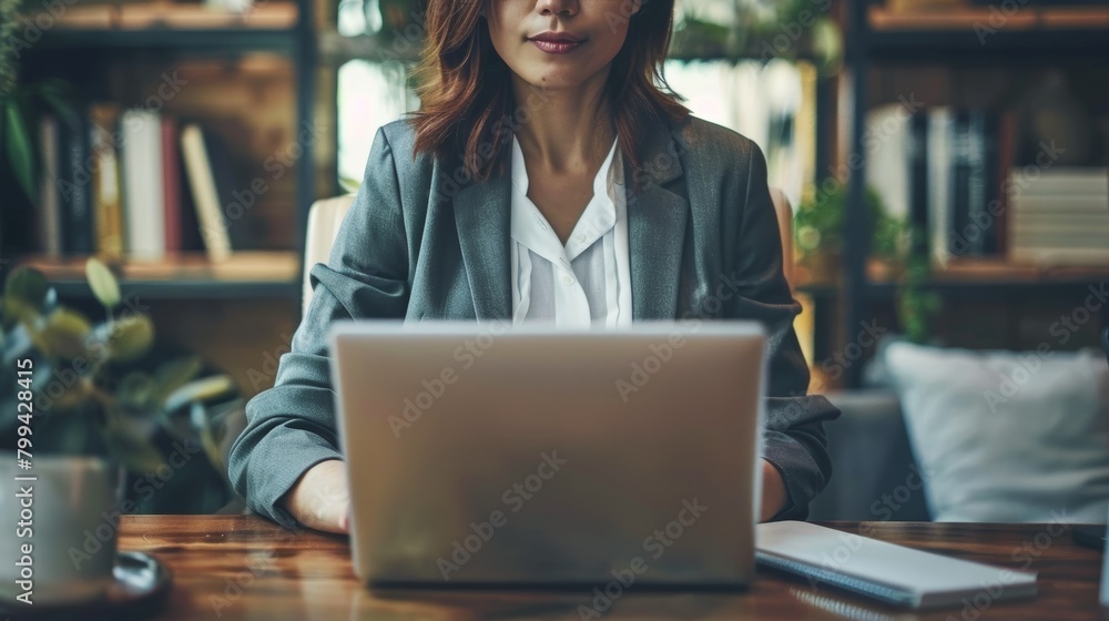 Woman Sitting at Table Using Laptop