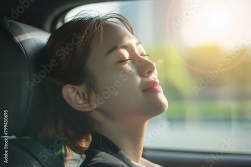 The photo captures a female passenger looking ahead, sunlight creating a dynamic lens flare effect