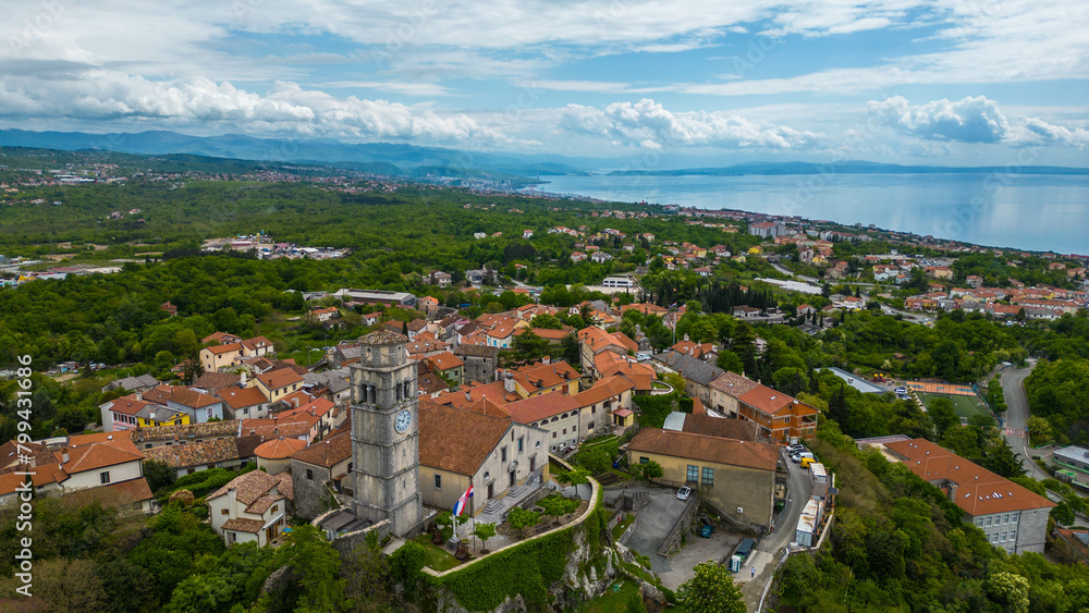 Obraz premium Kastav, a charming town perched on a hill overlooking the Adriatic Sea near Opatija, Croatia, offers a picturesque setting steeped in history and natural beauty captured by drone