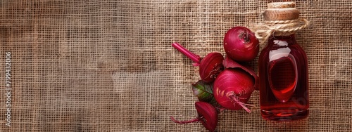 essential oil of red beet on the background of burlap top view