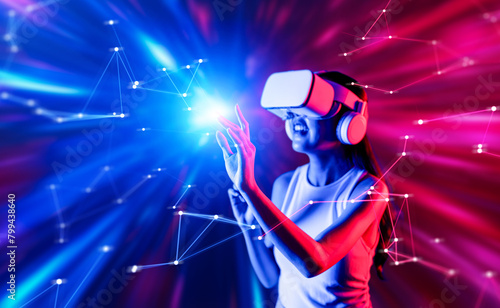 Smart female standing surrounded by neon light wearing VR headset connecting metaverse, future cyberspace community technology. Elegant woman using finger touch virtual reality object. Hallucination.