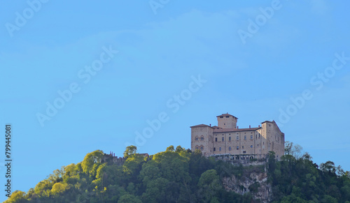Rocca di Angera, huge ancient fortress on high rock at Angera, Lago Maggiore, with blue sky