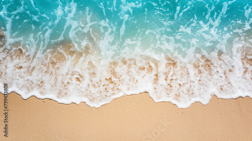 Top view of a tranquil beach shoreline with soft waves lapping over golden sand, creating a serene and peaceful natural background, perfect for relaxation and summer themes