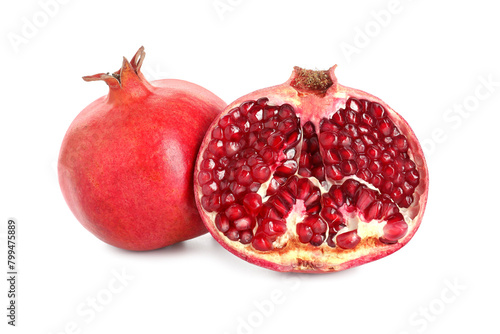 Half and whole pomegranates isolated on white