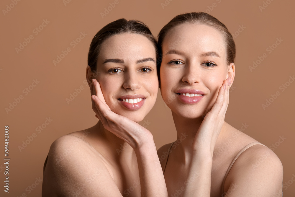 Young sisters on brown background Young sisters on brown background