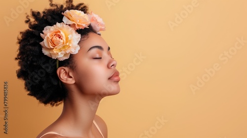 Young sensual african americal girl with flowers in her hair, copy space photo