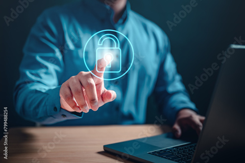 padlock, safety, identity, network, system, software, secure, code, privacy, private. A man is pointing to a laptop screen with a blue padlock virtual screen.