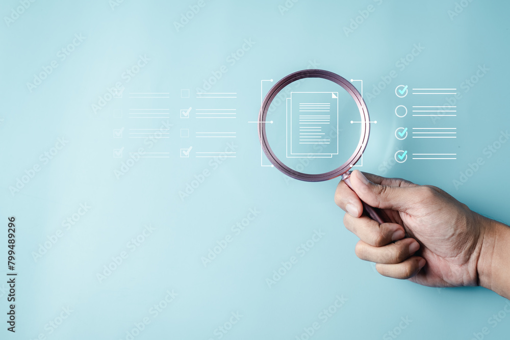 search, security, glass, browsing, discovery, find, global, exploration, research, magnification. A hand holding a magnifying glass with a lot of document. Concept of scrutiny and attention to detail.