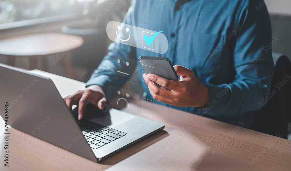 Fototapeta premium marketing, success, information, social, financial, network, office, software, finance, person. A man is using a smartphone and shows a smiley face, likely checking his social media or message.
