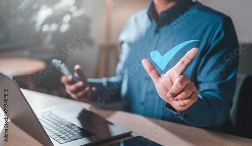 vote, result, satisfaction, positive, management, rate, social, evaluation, feedback, reputation. A man is holding a smartphone, and he is giving a thumbs up sign. Concept of approval or satisfaction.