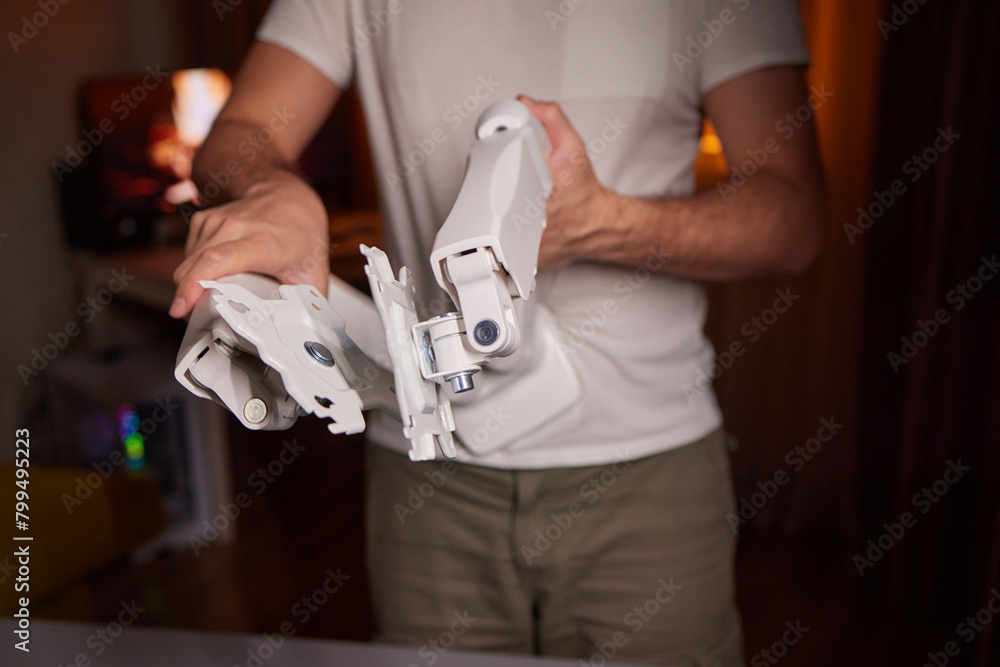 The hands of a young guy installing a computer monitor