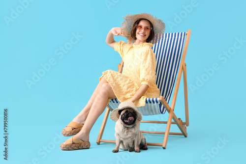 Young woman with cute pug d...