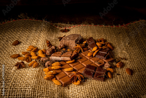 Photograph of pieces of chocolate with almonds on a rustic background