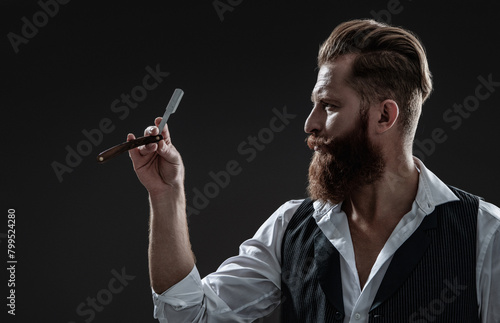 Barbershop. Man with red beard. Hairstylist at barber shop isolated on black. Barber using retro blade. Brutal hairdresser cutting hair. Hairstylist serving at barber shop. Getting perfect shape