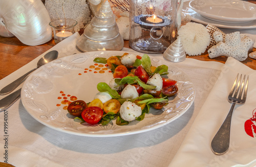 Caprese salad with cherry tomatoes, mozzarella, basil, and arugula
