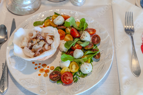 Seafood mix and Caprese salad with cherry tomatoes, mozzarella, basil, and arugula