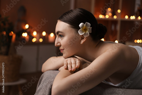 Spa therapy. Beautiful young woman lying on massage table in salon, space for text © New Africa