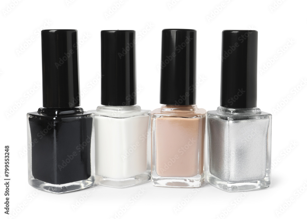 Beautiful nail polishes in bottles isolated on white Beautiful nail polishes in bottles isolated on white