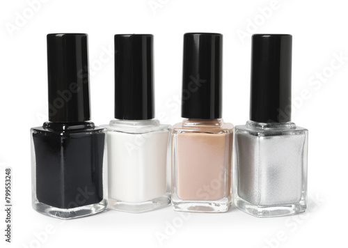 Beautiful nail polishes in bottles isolated on white