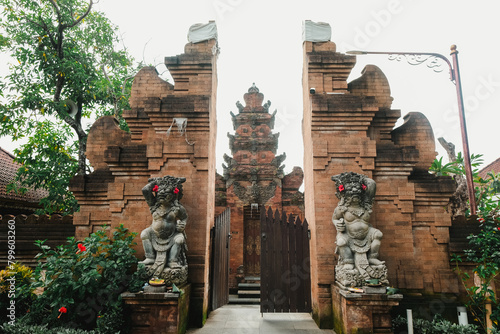 Balinese temple known as "Pura" entrance gate usually known as "Candi Bentar" with two guardian statues flanking the sides called Dwarapala