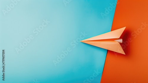 Orange paper plane on blue and orange background