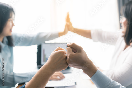 Successful businessman and businesswoman led their professional team in corporate office, where teamwork and collaboration were key to their success, leaving everyone happy after meeting together.