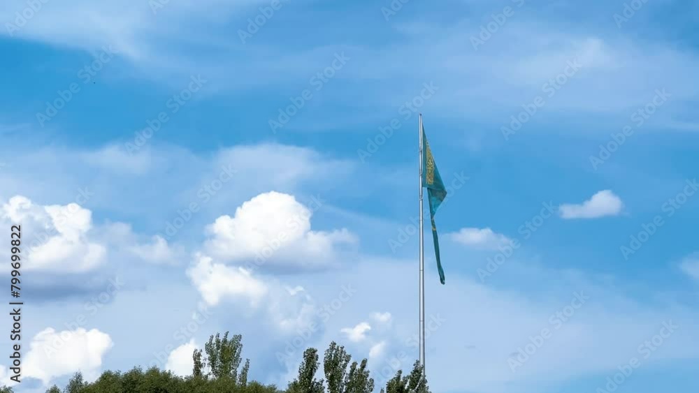 The flag of Kazakhstan is flying in the wind. Astana - Nur Sultan. A waving flag on a flagpole against the blue sky in Kazakhstan. The flagpole of the Republic of Kazakhstan on a bright sunny day. 4K The flag of Kazakhstan is flying in the wind. Astana - Nur Sultan. A waving flag on a flagpole against the blue sky in Kazakhstan. The flagpole of the Republic of Kazakhstan on a bright sunny day. 4K
