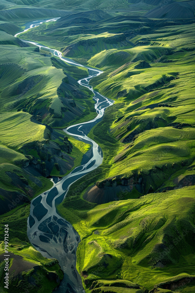 Aerial view of vivid green landscapes with a blur river flowing through the valley Aerial view of vivid green landscapes with a blur river flowing through the valley