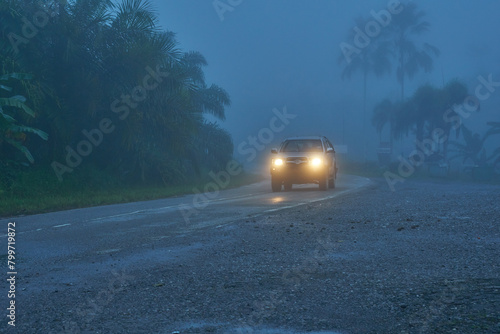 Light beam from a pickup truck in a foggy morning.
