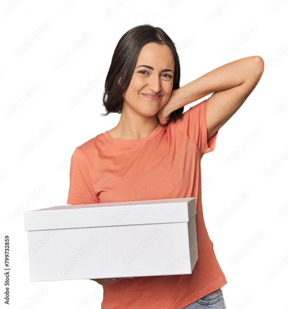 Young Caucasian woman holding a white box touching back of head, thinking and making a choice. Young Caucasian woman holding a white box touching back of head, thinking and making a choice.