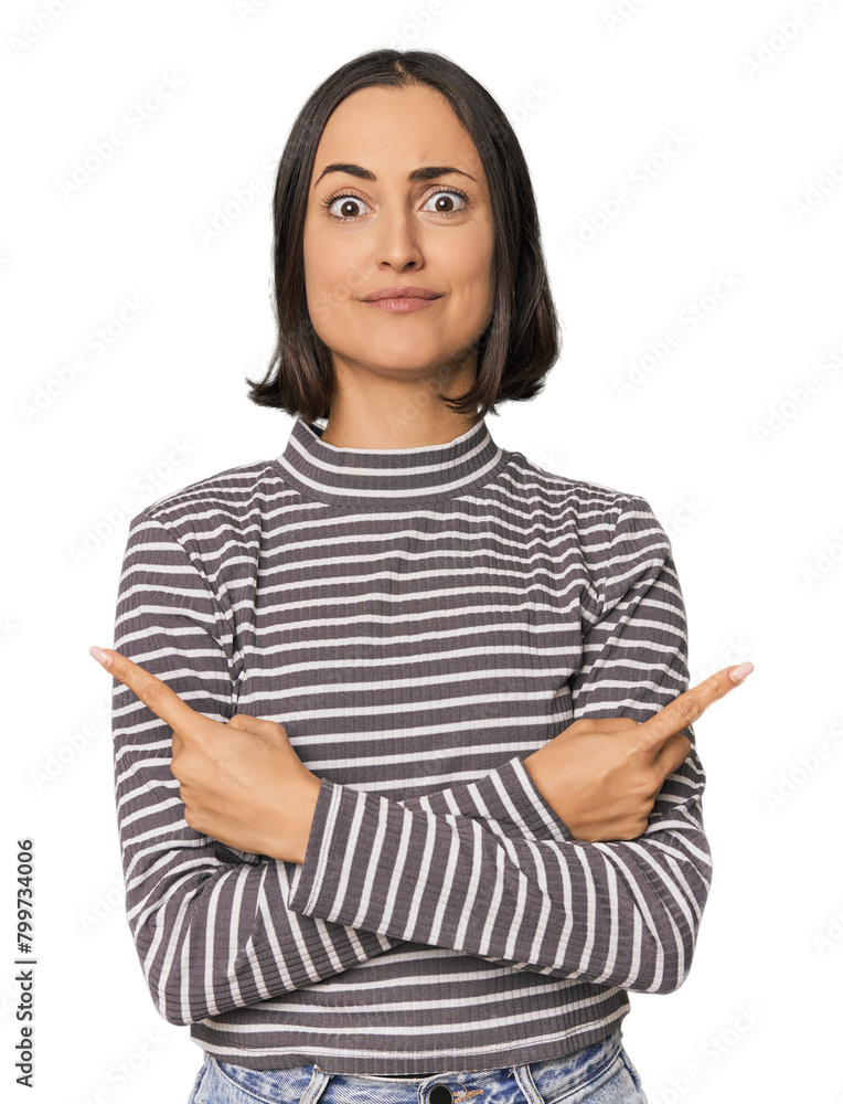 Young Caucasian woman with short hair points sideways, is trying to choose between two options. Young Caucasian woman with short hair points sideways, is trying to choose between two options.